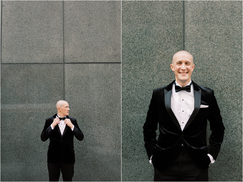 groom in classic tux poses on Philadelphia street