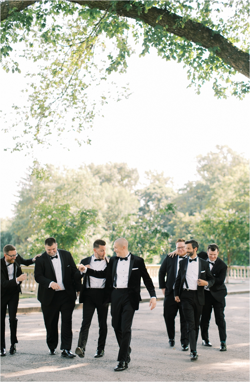 groom and groomsmen walk around Curtis Arboretum