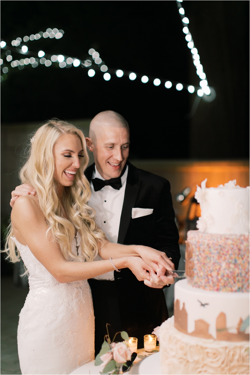 bride and groom cut tiered wedding cake at Curtis Arboretum