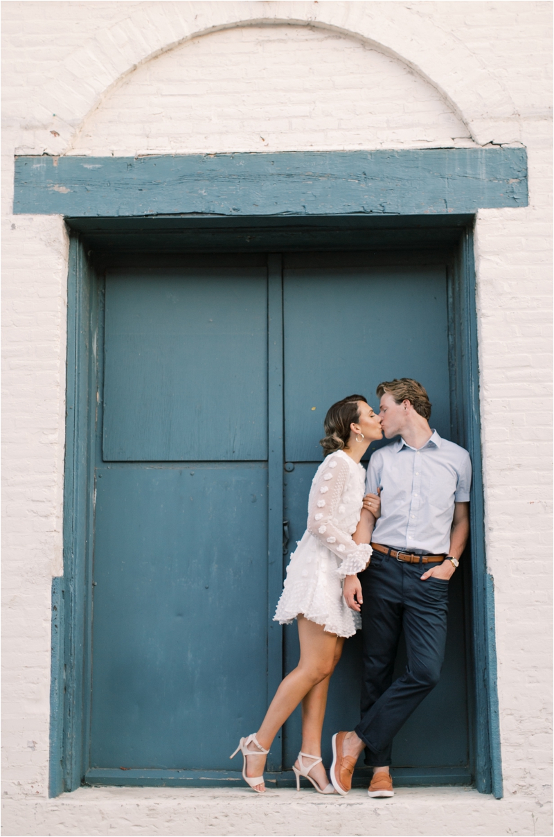 couple poses in doorway in Downtown Lancaster