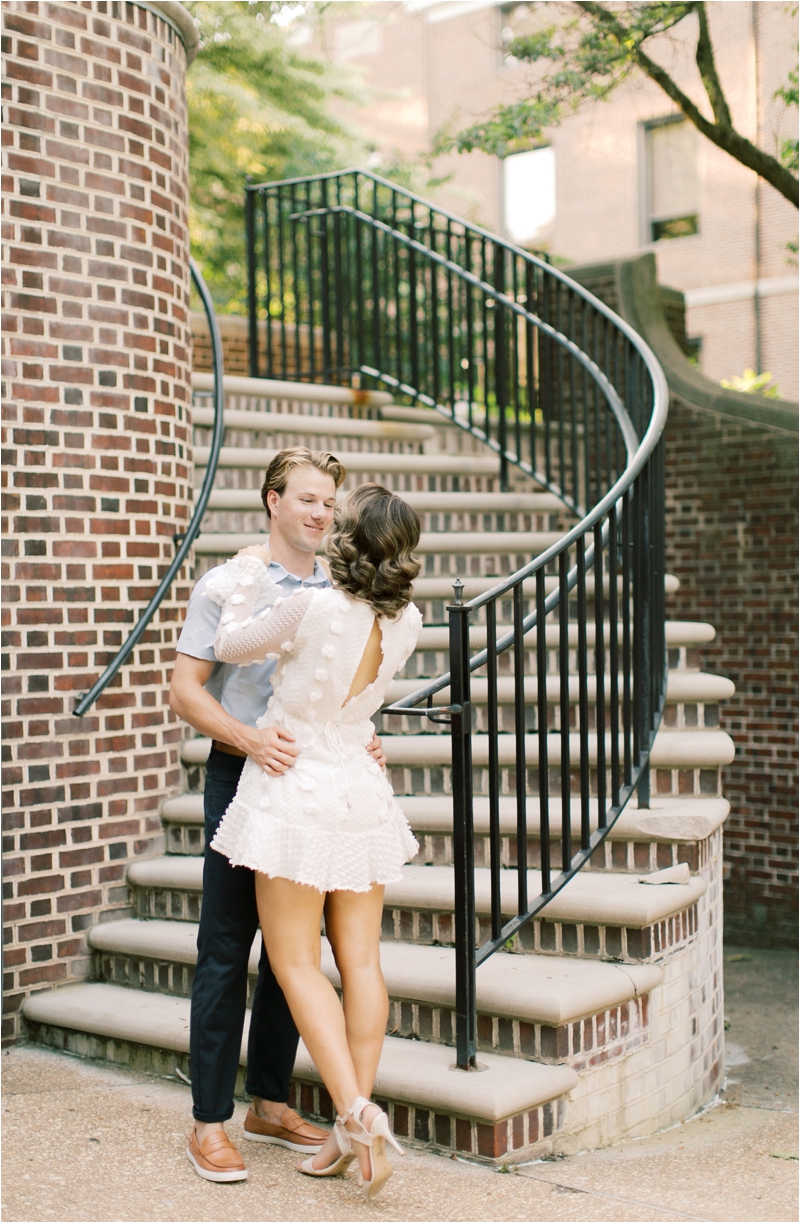engaged couple poses by spiral staircase in Pennsylvania 