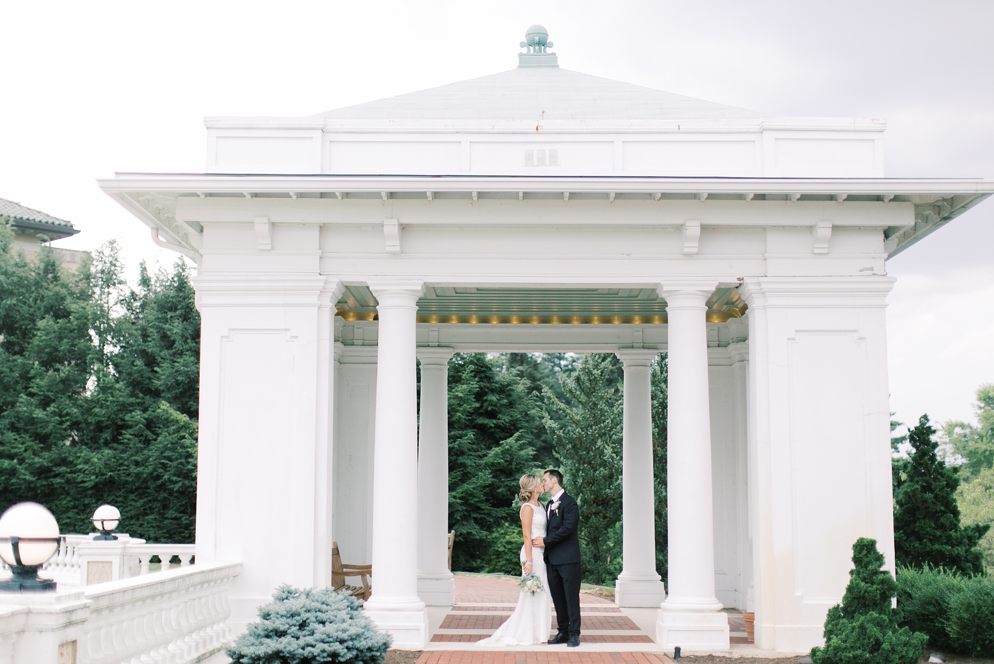 bride and groom kiss under pavilion at the Hershey Hotel