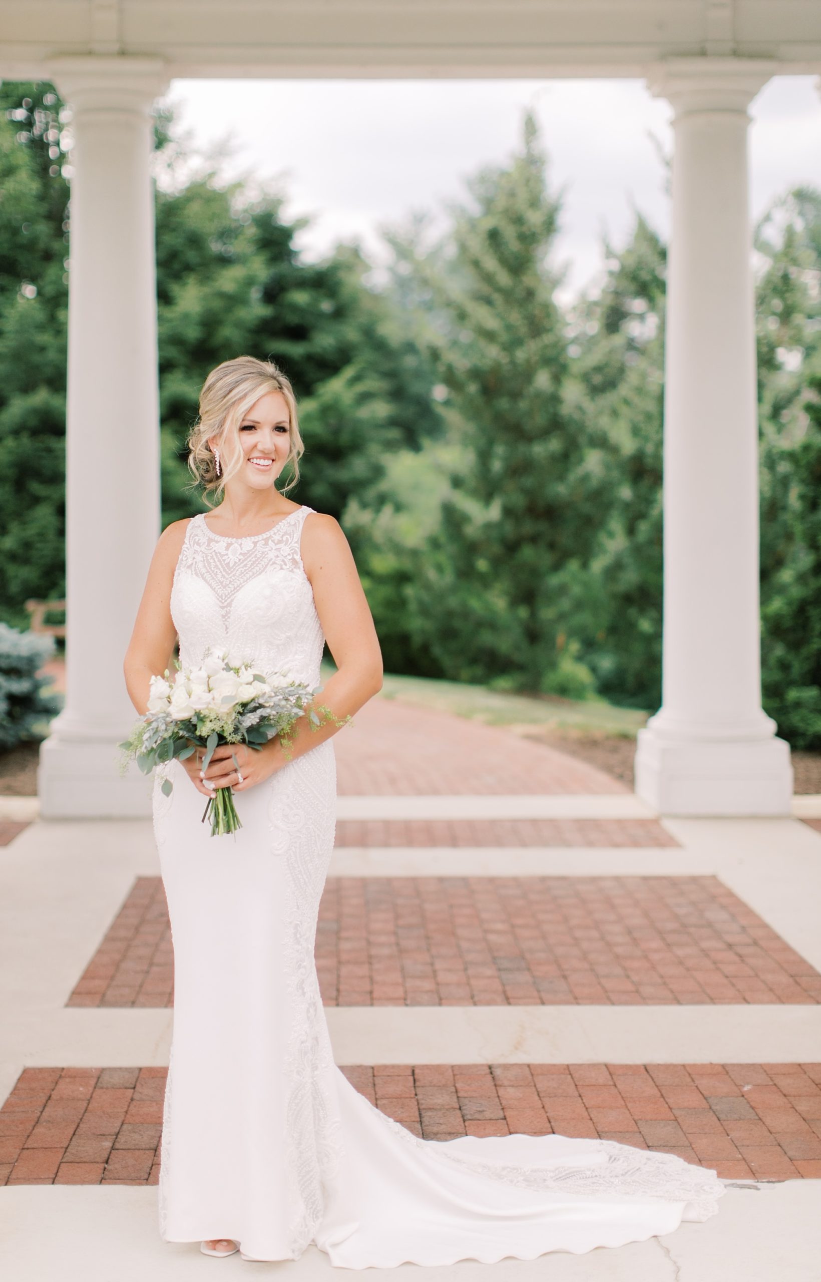 bride holds bouquet of white flowers at The Hershey Hotel