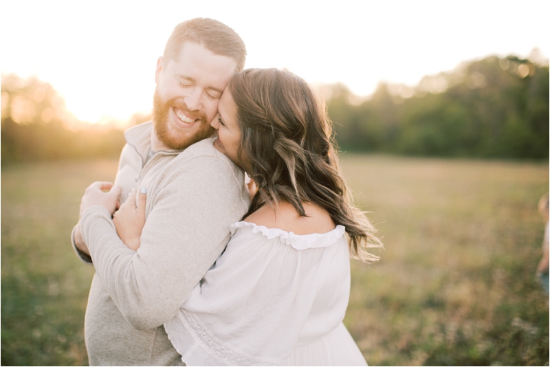 wife kisses husband's cheek during farm family photos
