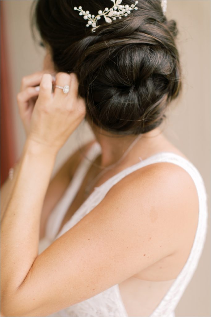 bride adjusts earrings for Ironstone Ranch wedding day