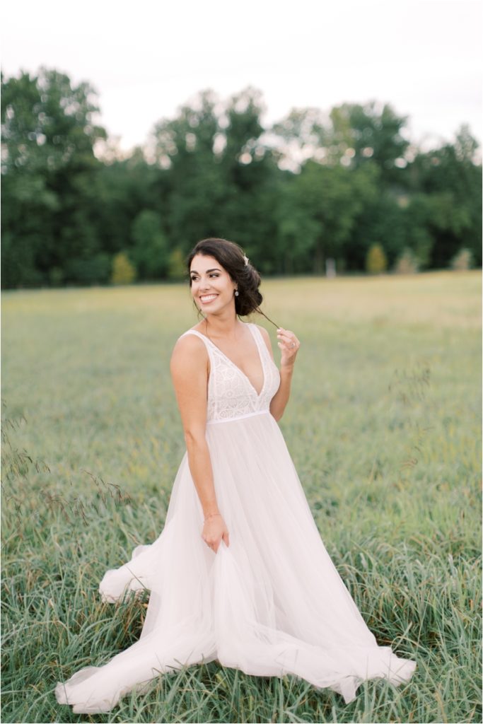 bride twirls in field during PA wedding photos