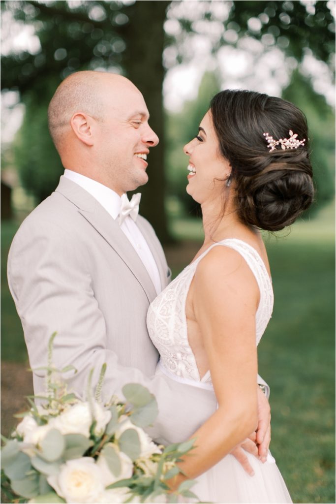 newlyweds laugh during Elizabethtown PA wedding photos