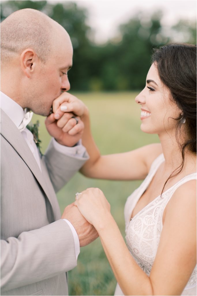 groom kisses bride's hand during PA wedding photos