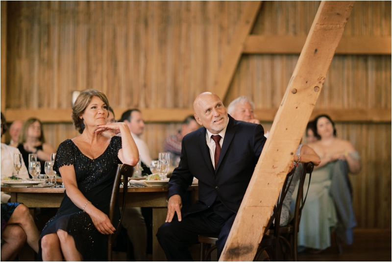 parents watch newlyweds dance at reception