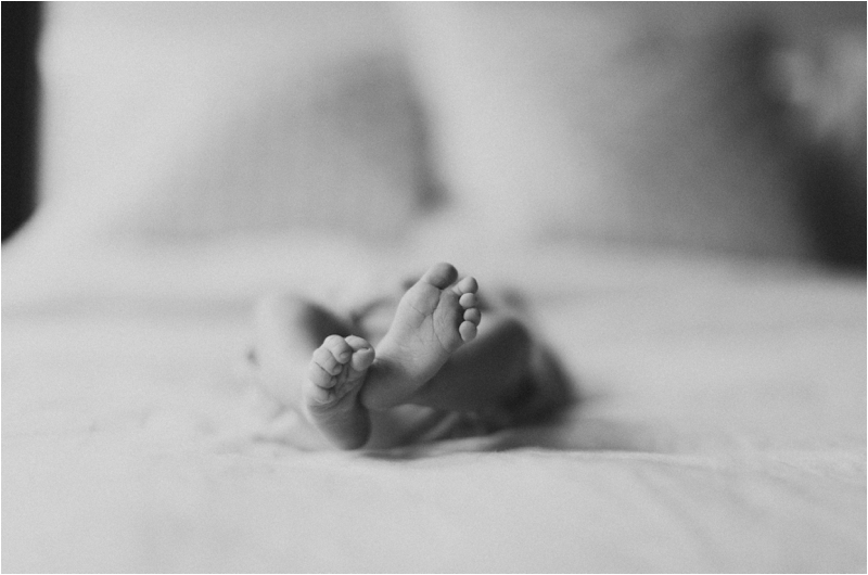 baby toes stacked on bed during lifestyle photos