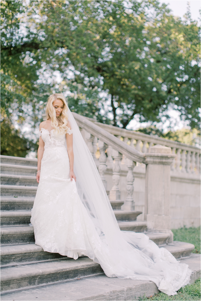 bride poses on steps of Curtis Arboretum 