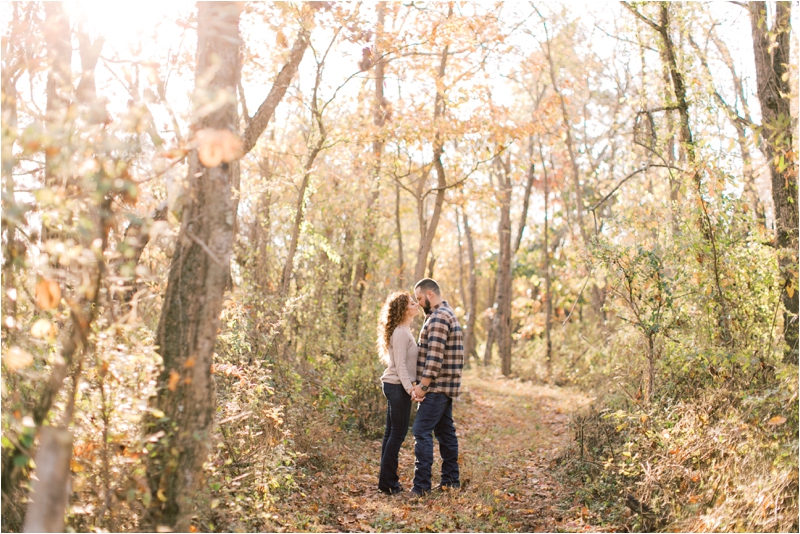 couple walks on path during fall farm engagement session