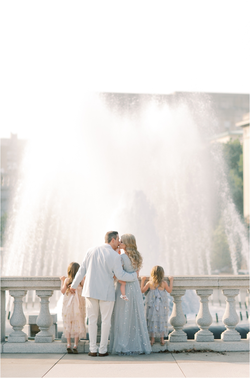 family looks at fountain during Harrisburg Capitol family session