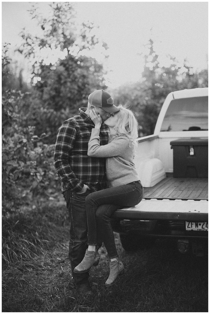 couple laughing and sharing a candid moment. Black & white photo of couple kissing. 