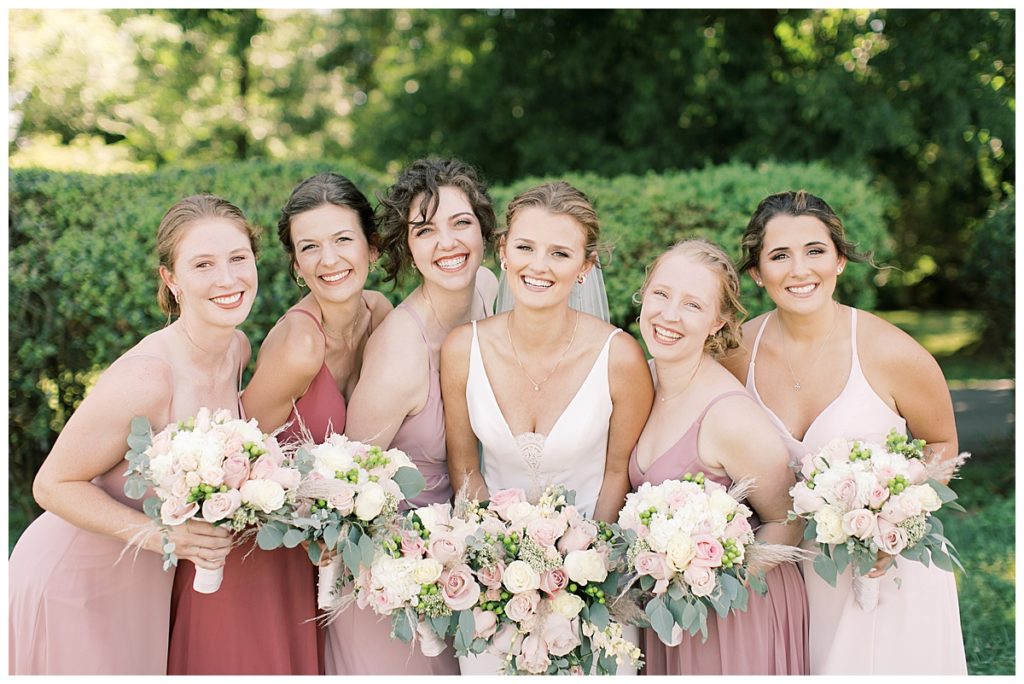 bridesmaid smiling photo with pink flowers 